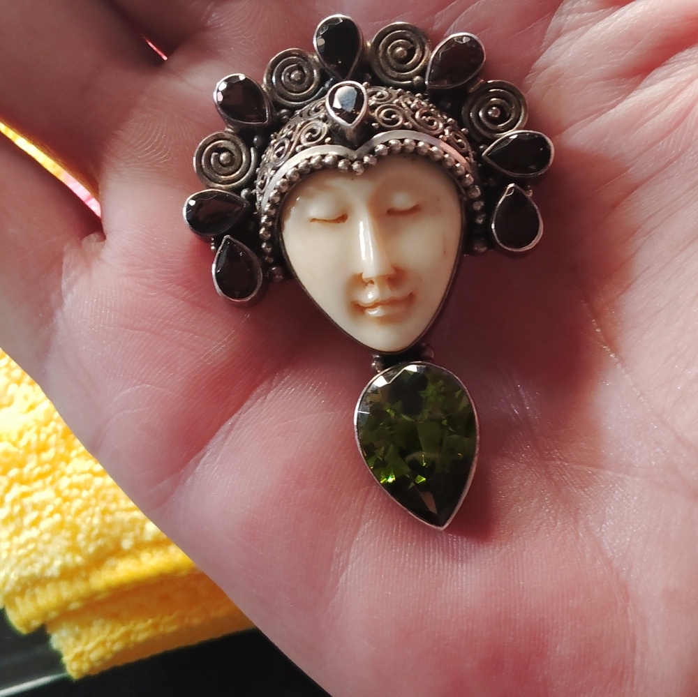 Intricate Silver and Green Brooch with Cream Face